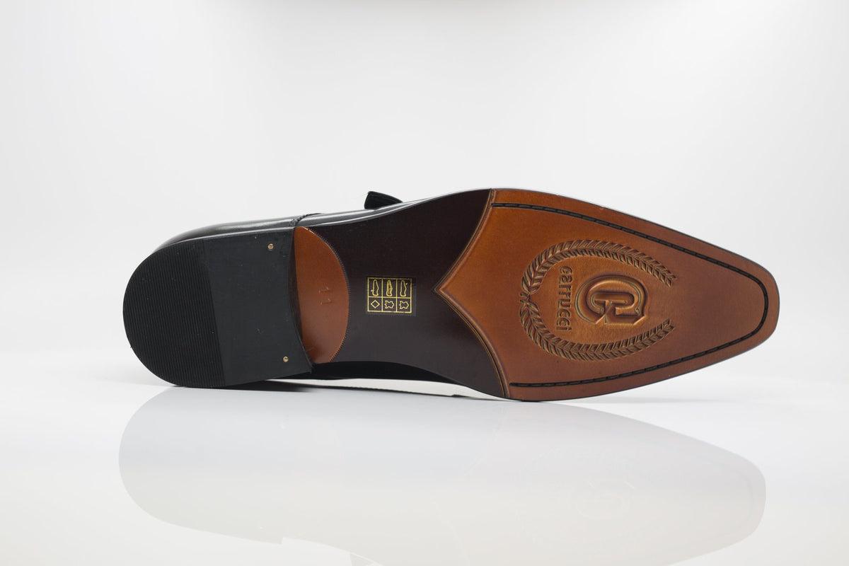 Leather sole view of monk strap dress shoe with brand embossing on footbed