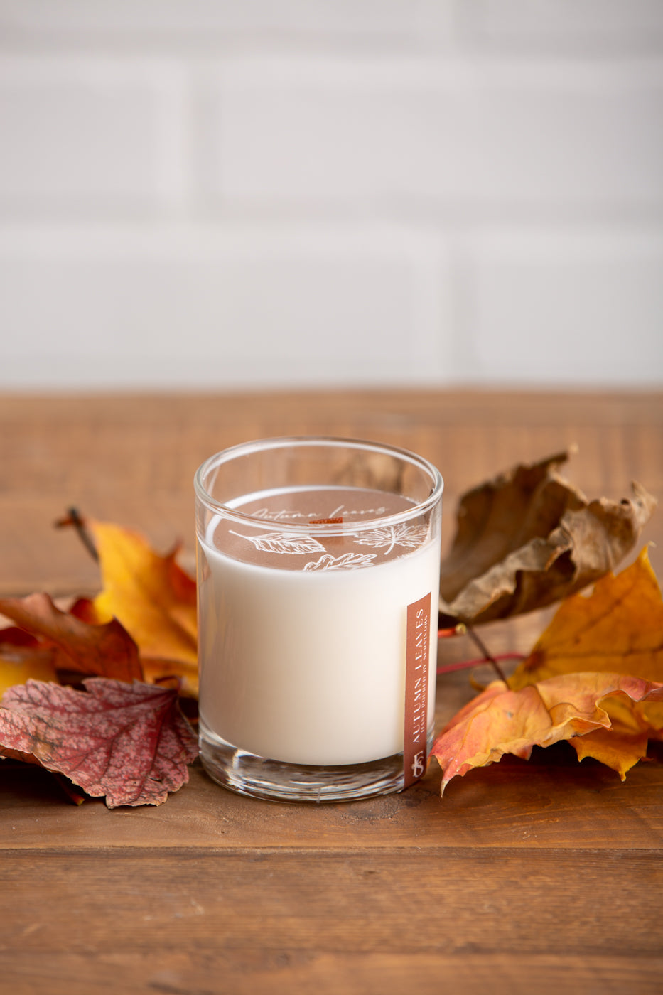 Autumn Leaves wooden wick candle in clear glass jar with off-white wax