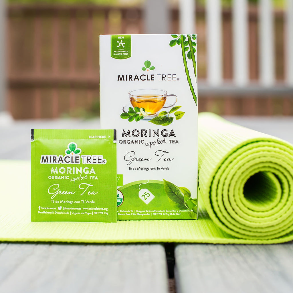 Miracle Tree moringa organic green tea boxes with tea cup illustration