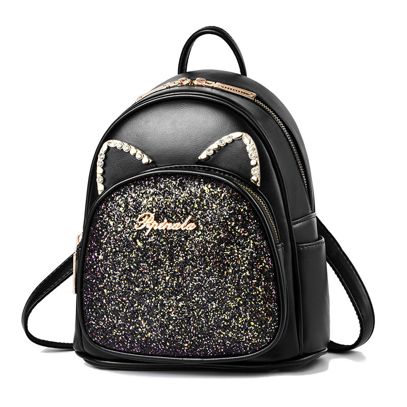 Black PU leather backpack with glitter front pocket and rhinestone arch detail, front zipper.