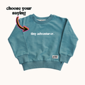 Kids teal organic pullover with long sleeves, crew neck, ribbed cuffs and hem.