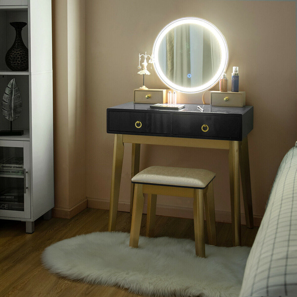 Makeup vanity table set with lit round mirror, black tabletop drawers, and beige stool