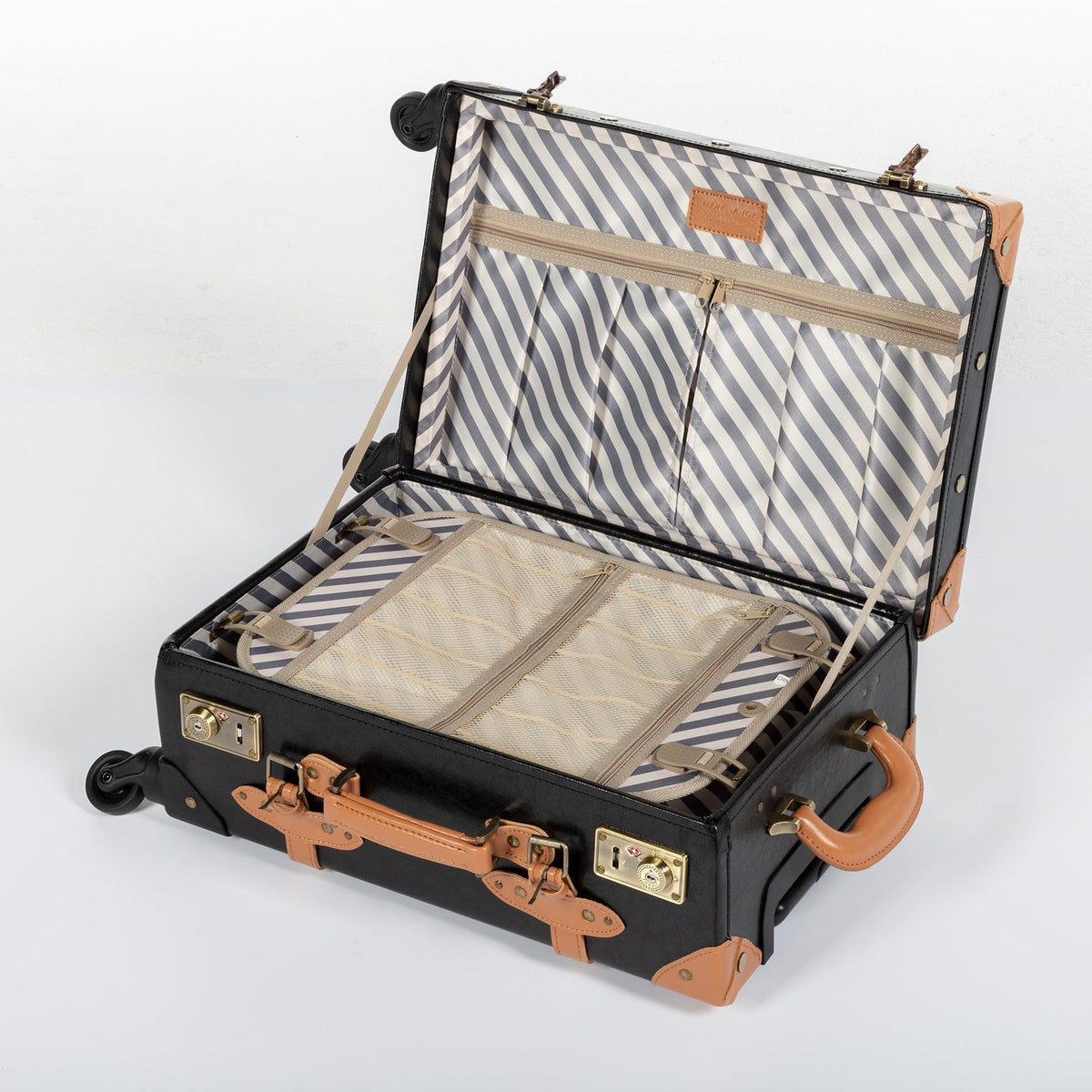 Open black hard-shell suitcase with striped lining, interior compartments, and tan straps