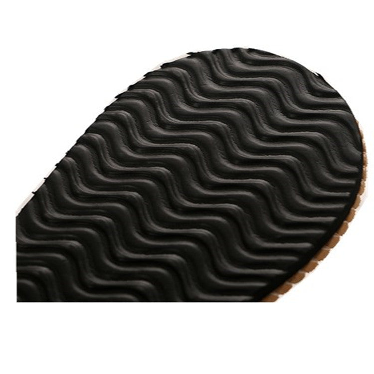 Women's black flip-flop outsole with wavy tread pattern underside