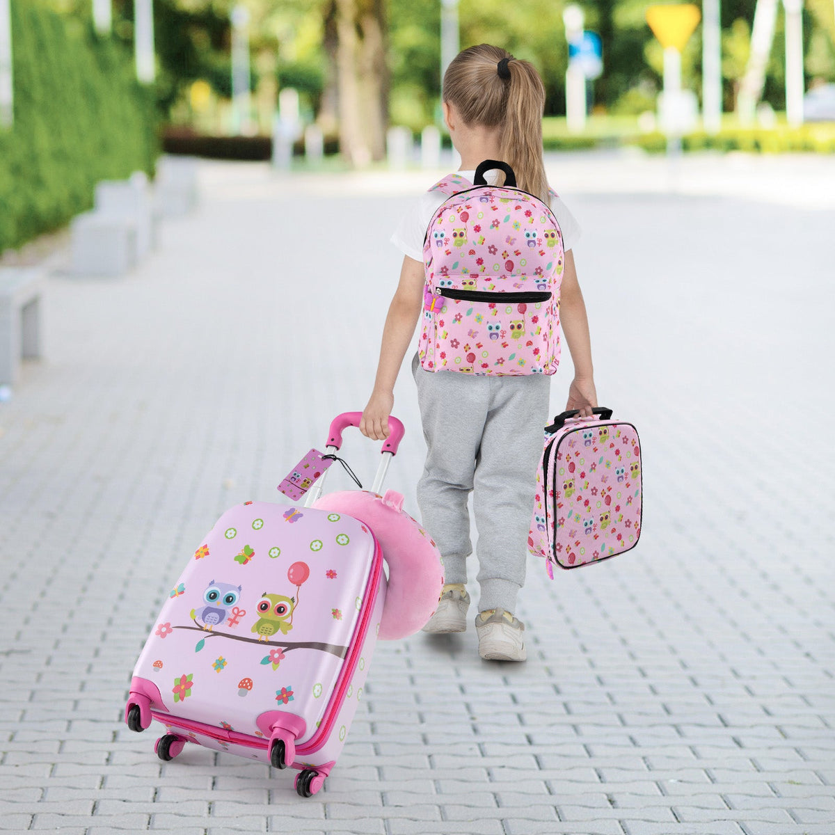 Kids rolling luggage set in pink with matching backpack, lunch bag, and neck pillow