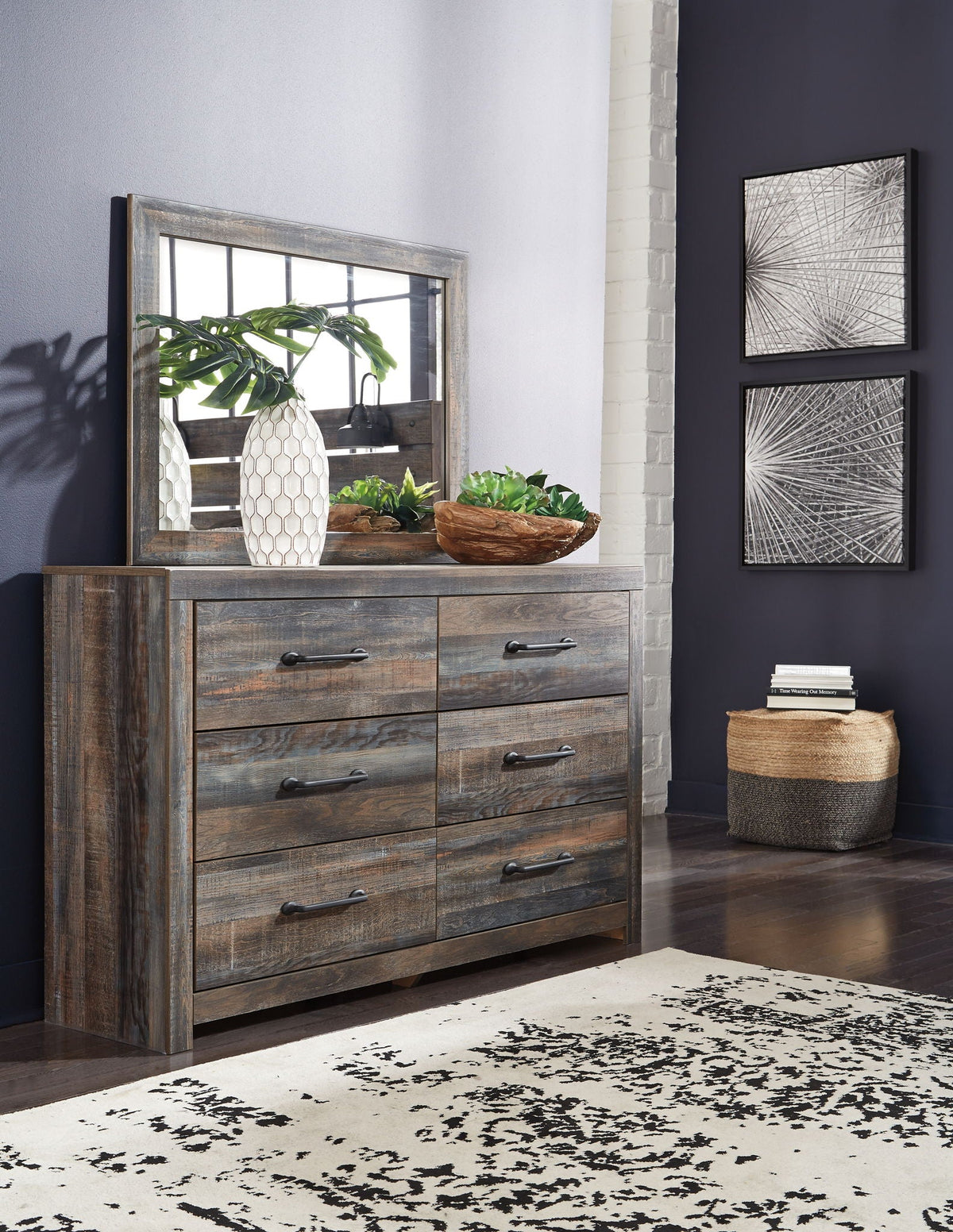 Wood dresser with gray-brown finish and black knobs, with rectangular wall mirror