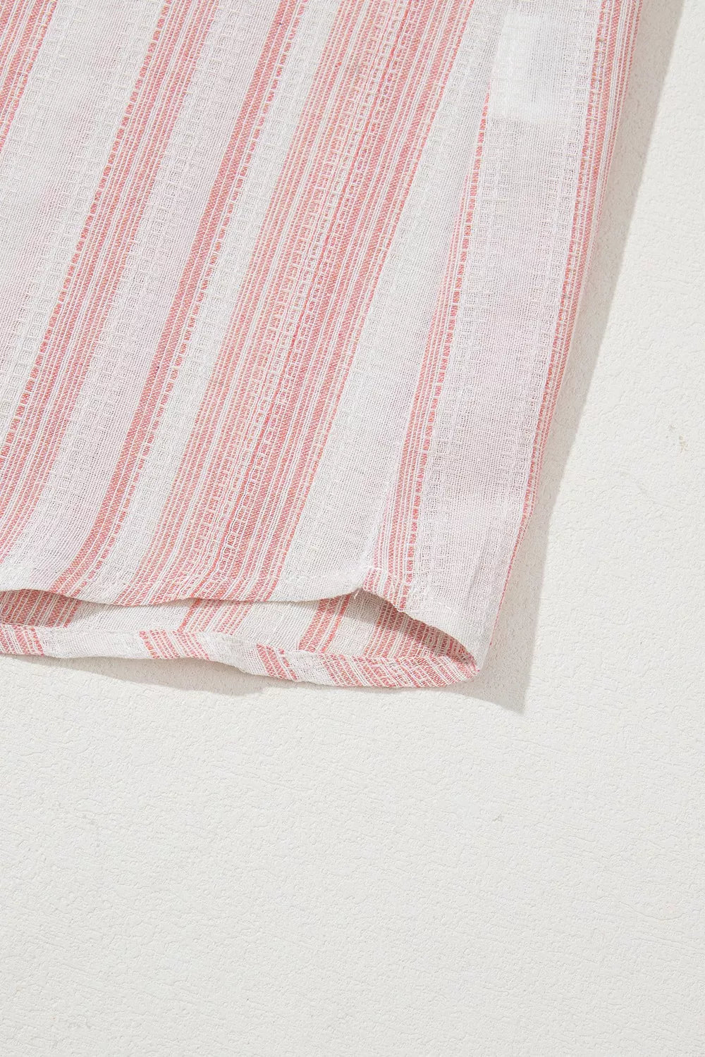 Dusty pink striped blouse hem detail with short cuffed sleeve edge