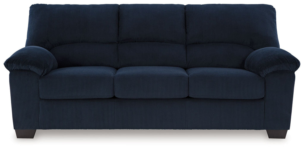 Navy corduroy sofa with tufted back, cushioned arms, and three seat sections