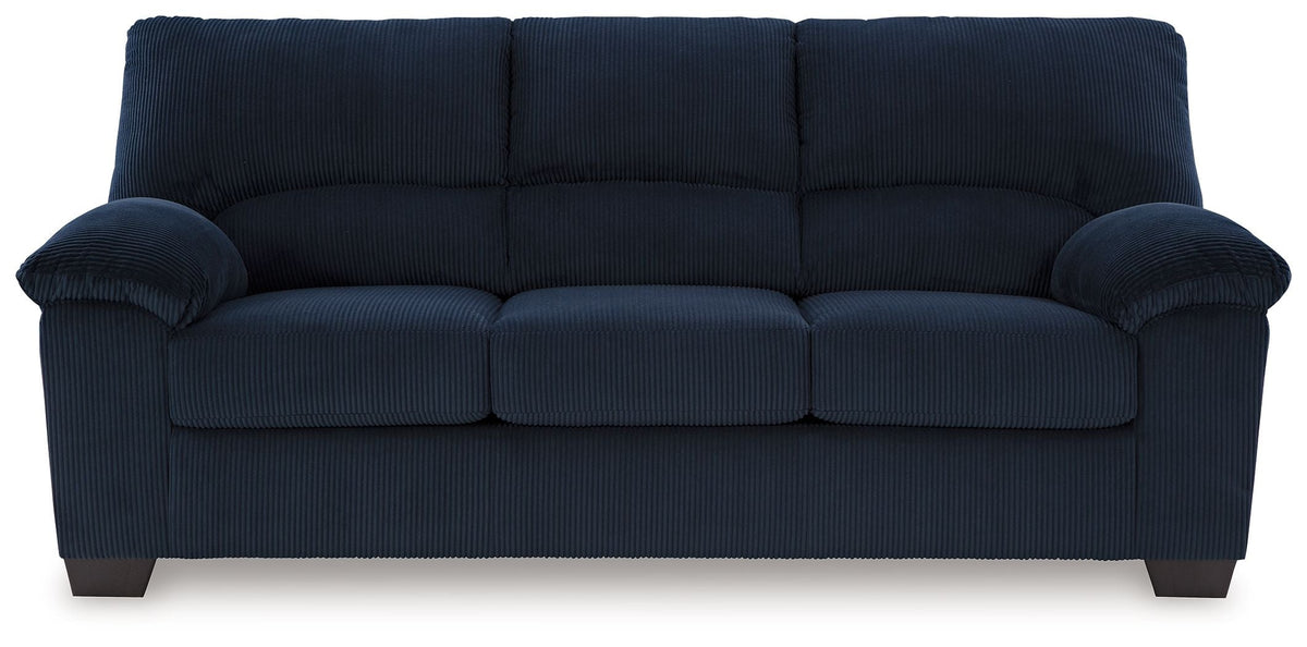 Navy corduroy sofa with tufted back, cushioned arms, and three seat sections