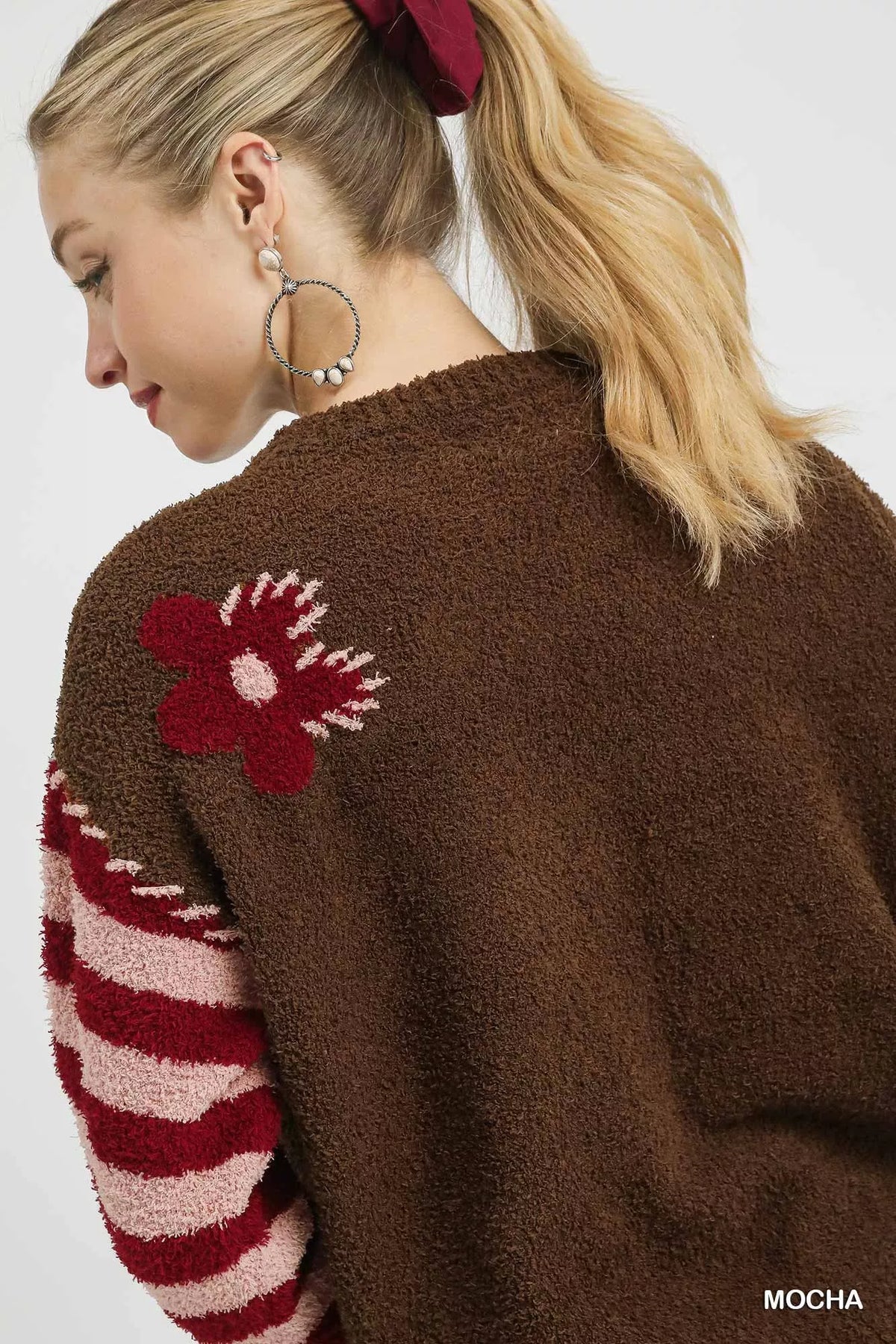 Mocha brown sweater back with red flower jacquard detail and striped sleeve