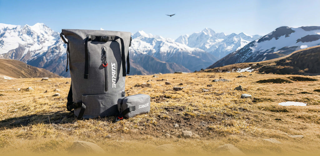 Gray waterproof 30L roll-top backpack with side compression straps and attached bottom pouch