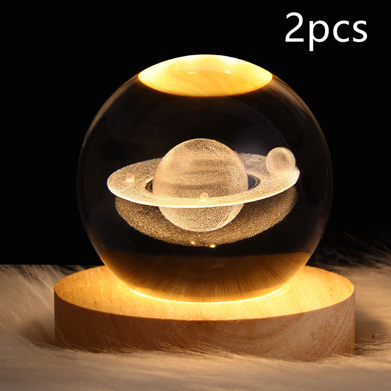 Galaxy crystal ball table lamp with glowing ringed planet in clear glass globe
