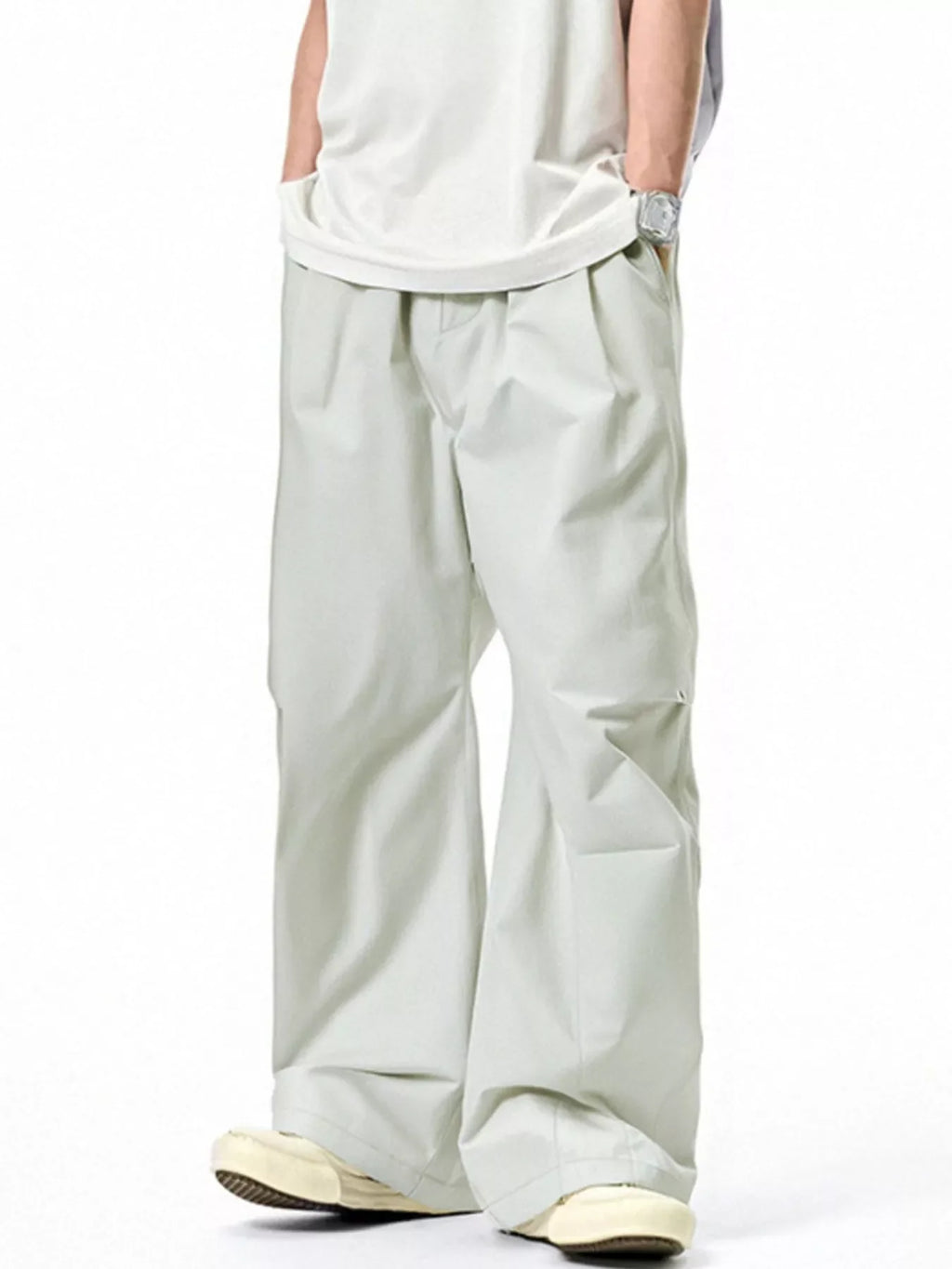 Light gray loose-fit casual pants with elastic waistband, drawstring, and roomy wide legs.