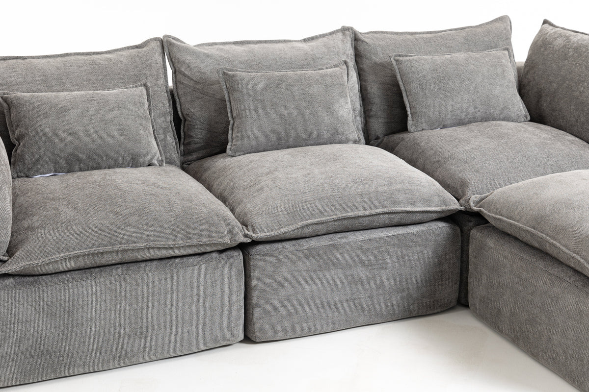 Close-up of gray sectional sofa cushions, seat, and back pillows with rounded arms