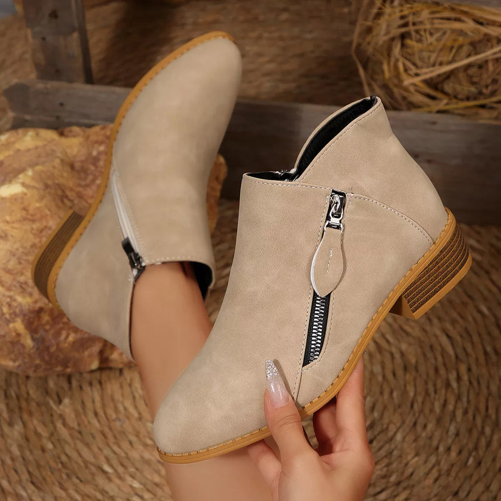 Light beige suede block-heel ankle boots with side zipper and textured outsole