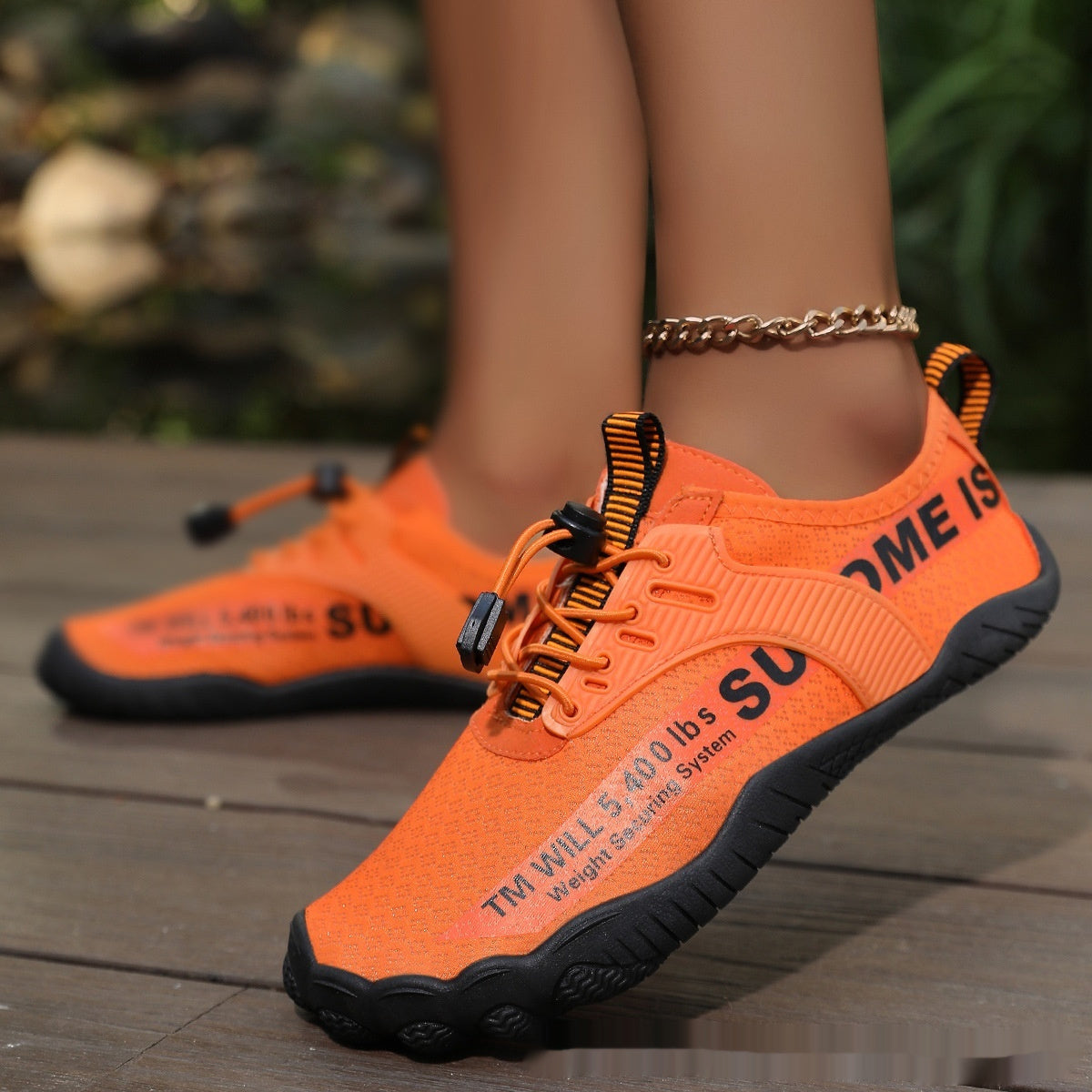 Orange lace-up water shoes with black trim and textured rubber sole