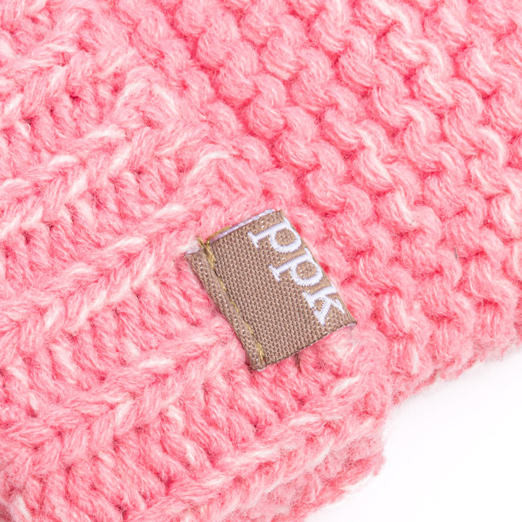 Pink knitted mitten cuff with small woven brand tag patch