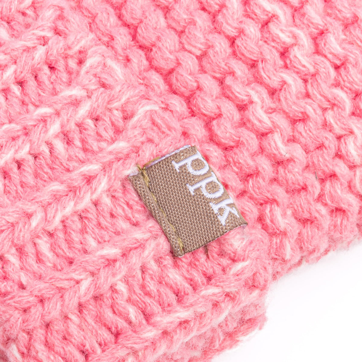Pink knitted mitten cuff with small woven brand tag patch