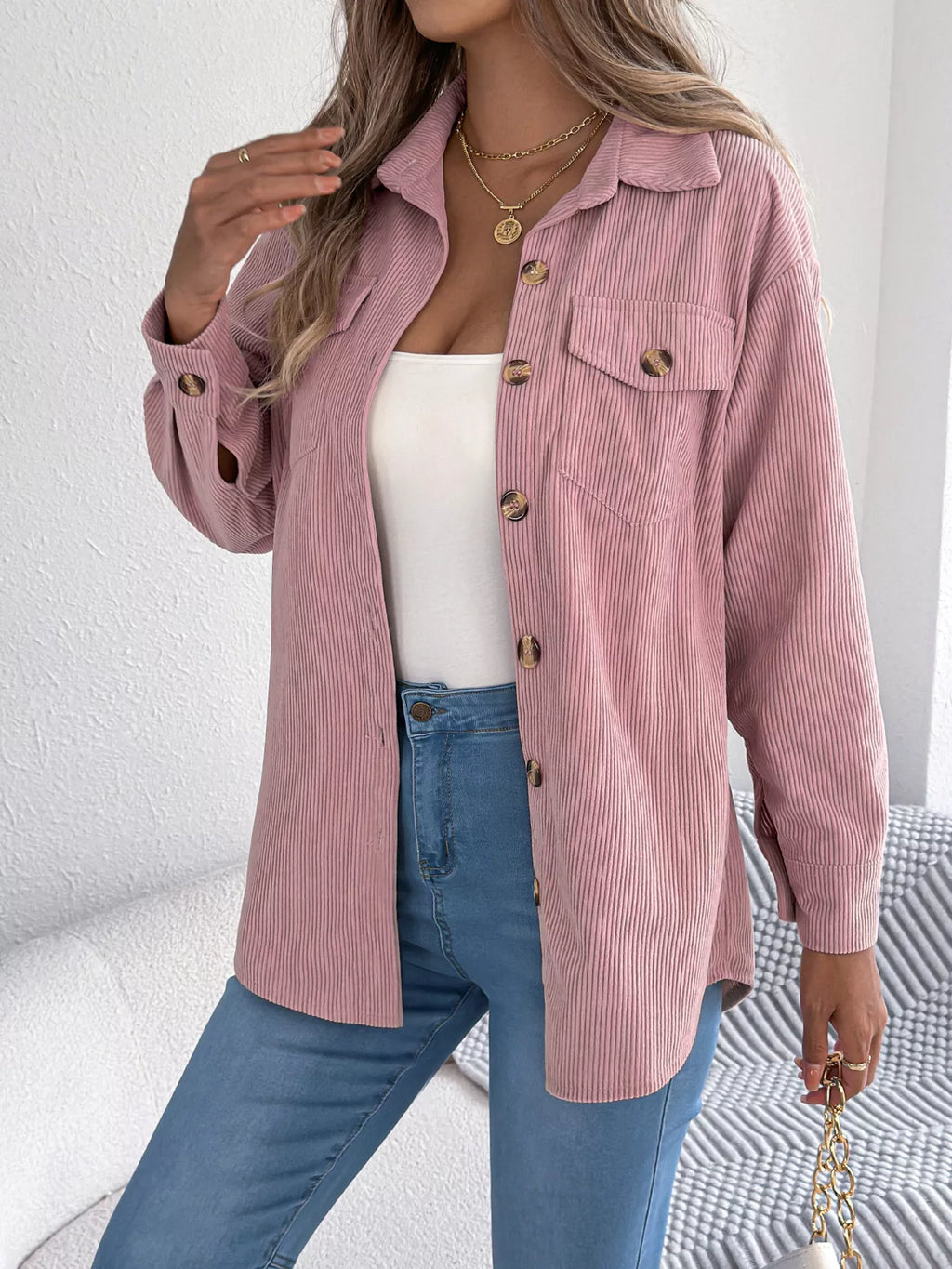 Pink corduroy button-up shacket with chest flap pockets and gold button accents