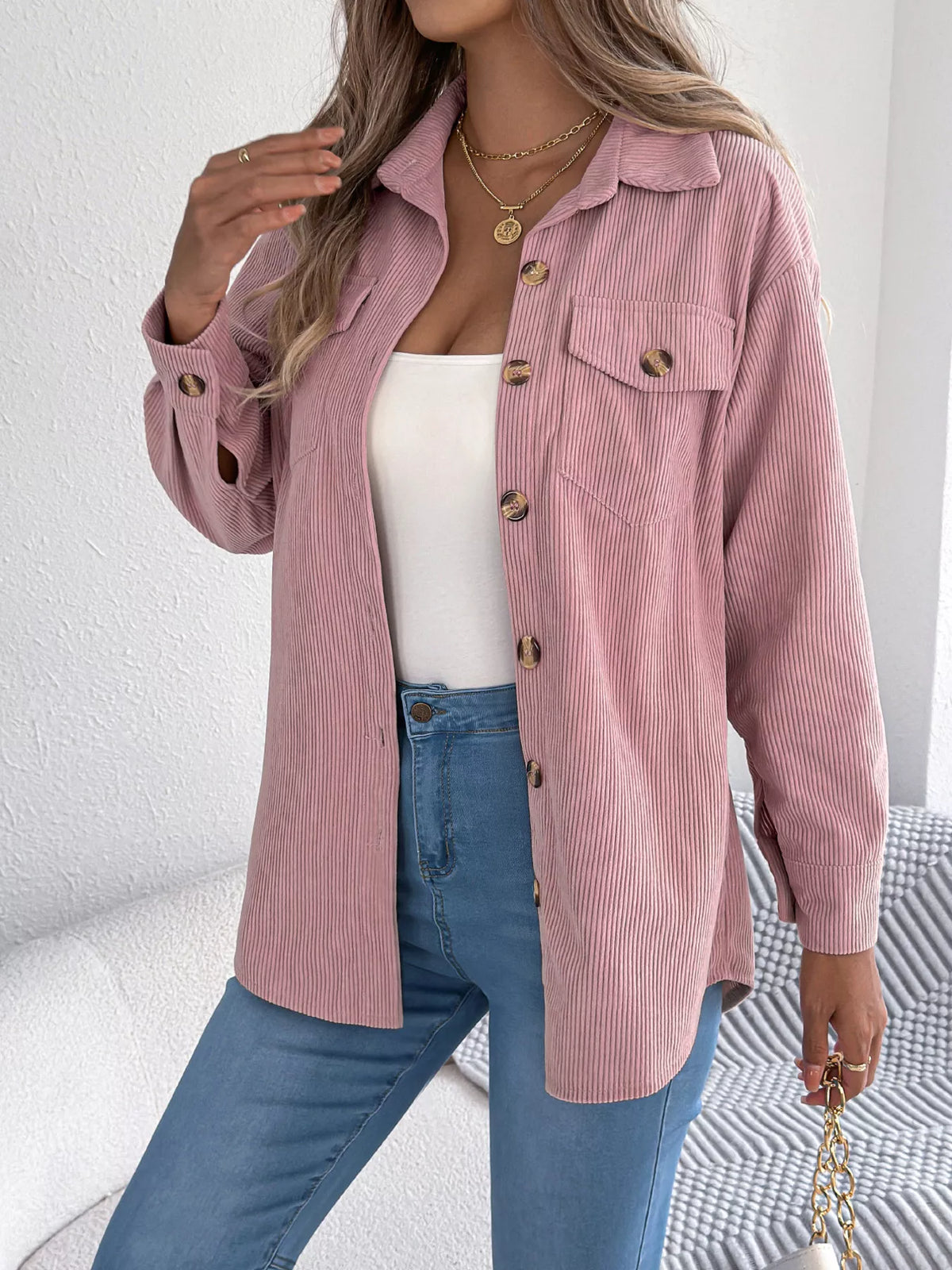 Pink corduroy button-up shacket with chest flap pockets and gold button accents