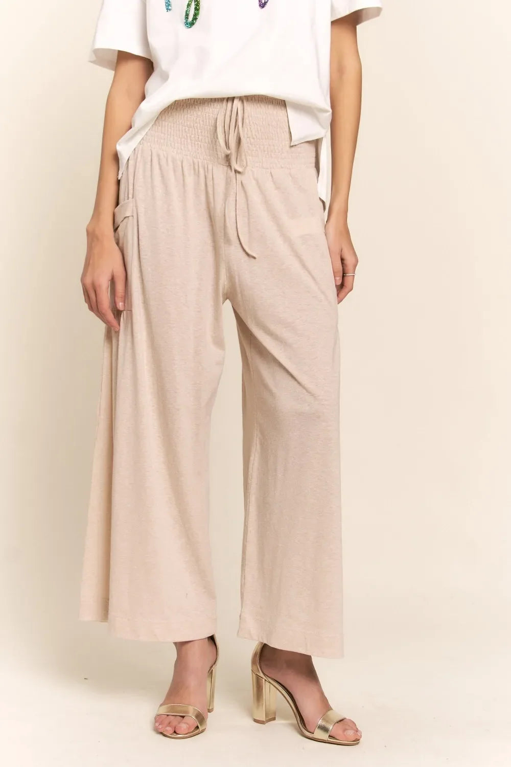 Light beige smocked-waist boho wide-leg pants with side pockets
