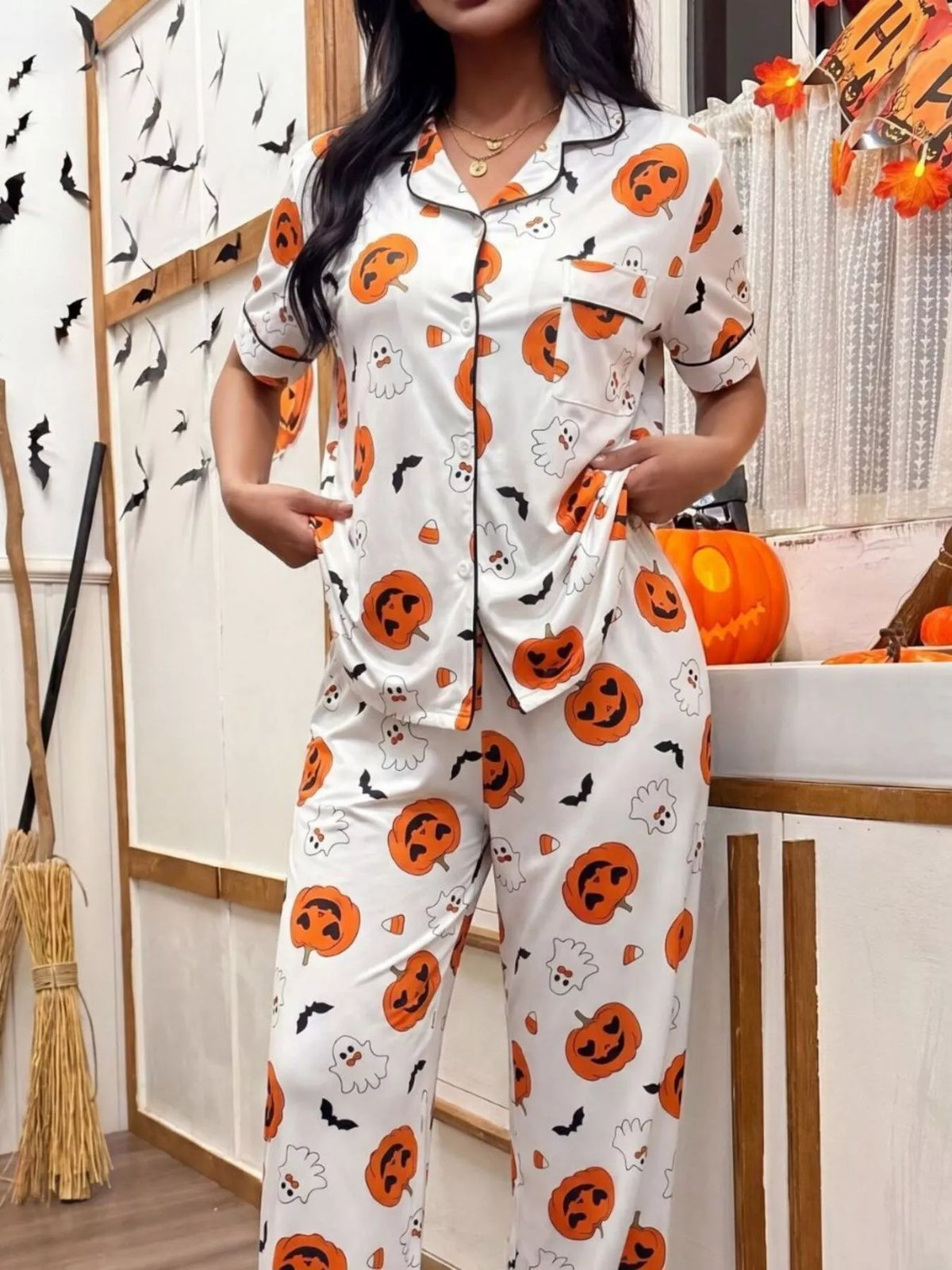 White Halloween pajama set with pumpkin and ghost designs, button-front shirt and straight-leg pants