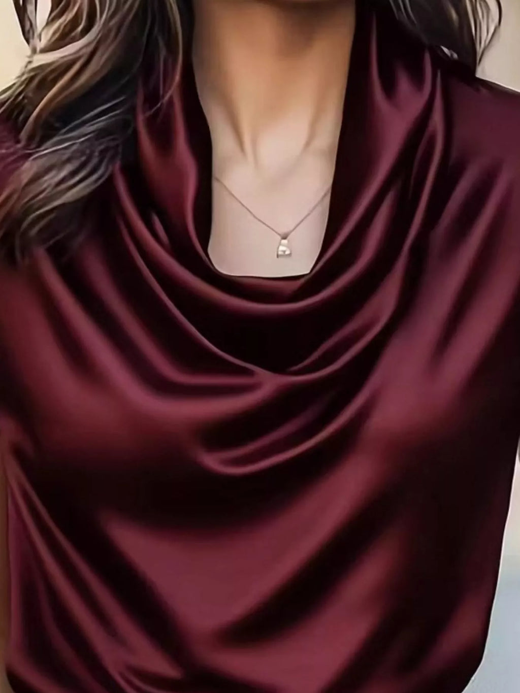 Burgundy satin cowl neck blouse close-up with draped cowl neckline.