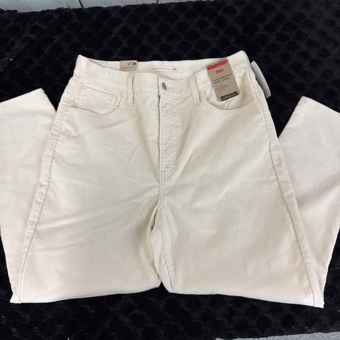 Cream corduroy mom jeans, high-waist style with button fly and side pockets