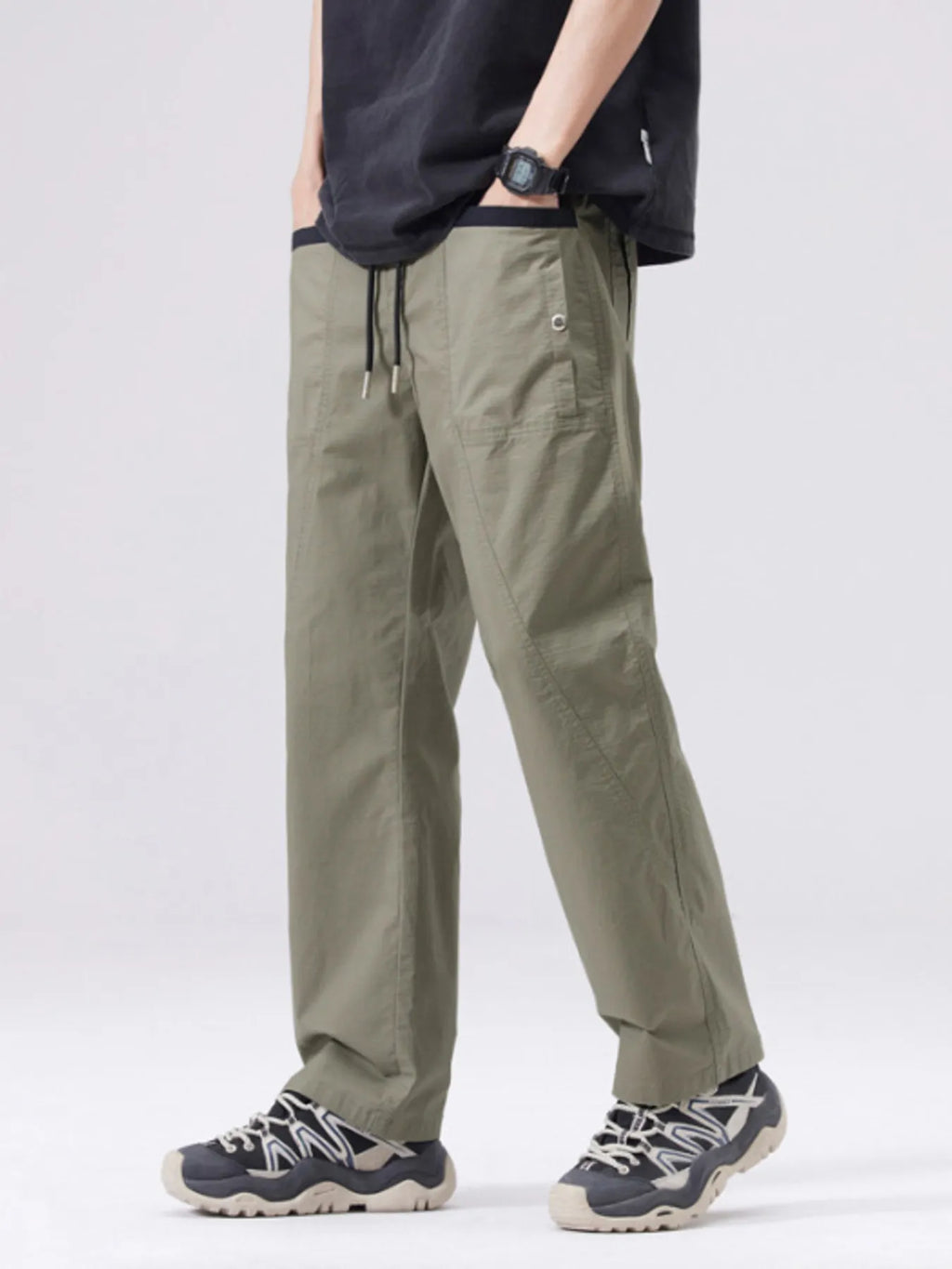 Men's army green cargo pants with drawstring waist and zip cargo pocket detail.