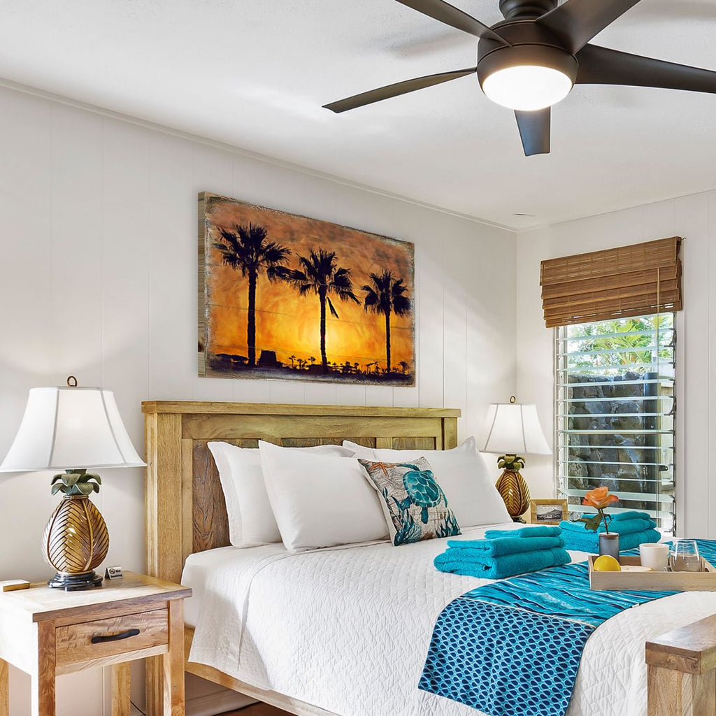 Palm tree sunset wall art above bed, rectangular wood panel with palm silhouettes
