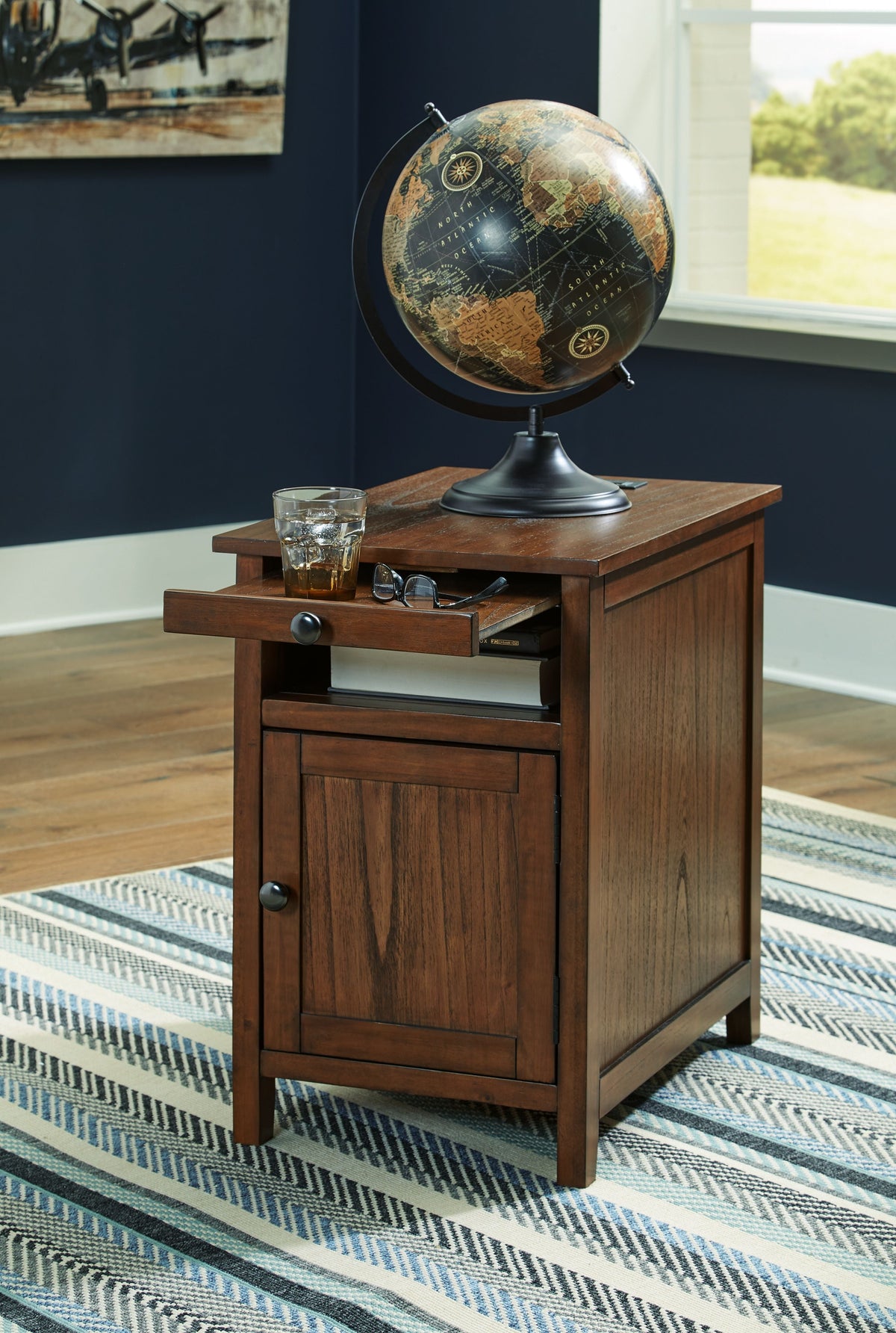 Chair side end table in warm dark brown wood with cabinet door and round knob