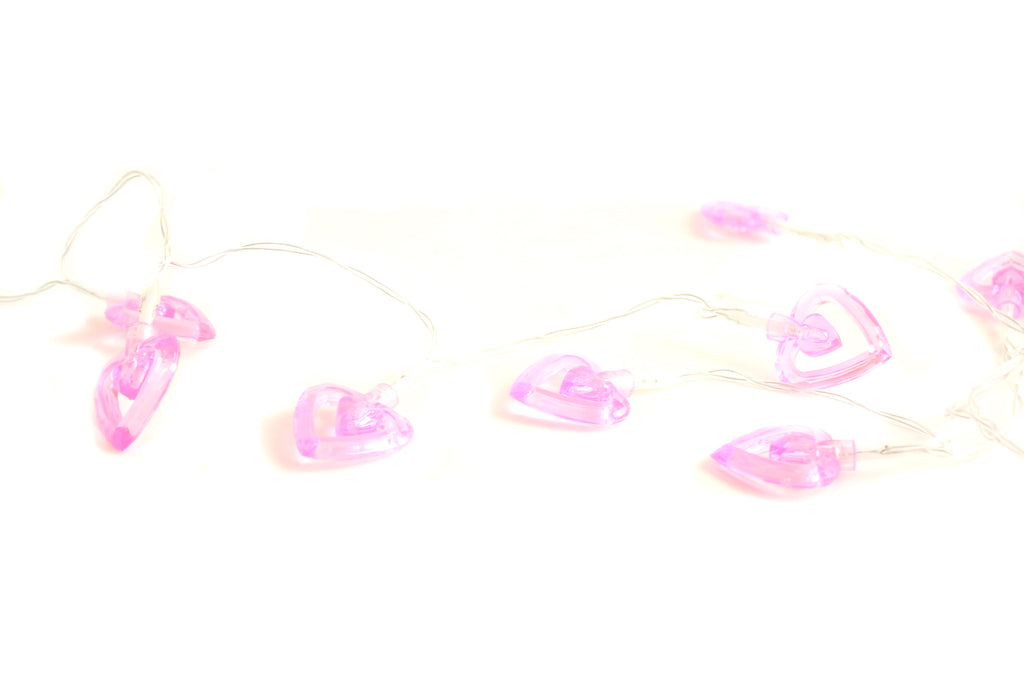 Clear wire string of pink LED heart lights with several heart bulbs lit