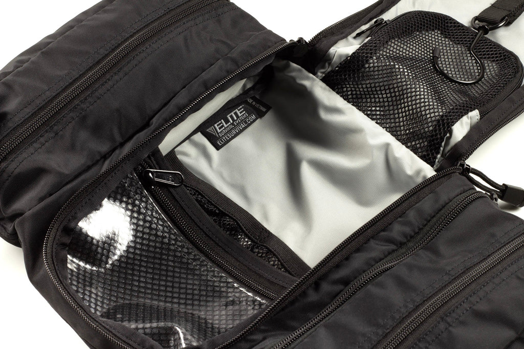 Inside dark toiletry kit with multiple zippered mesh and fabric compartments