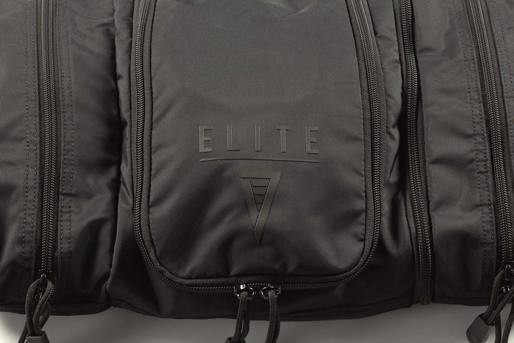 Front panel of dark toiletry kit with “ELITE 7” logo and zipper pocket