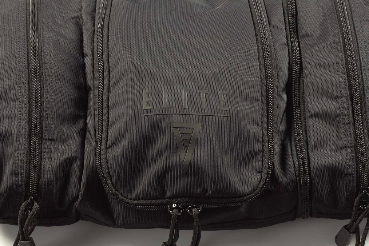 Front panel of dark toiletry kit with “ELITE 7” logo and zipper pocket