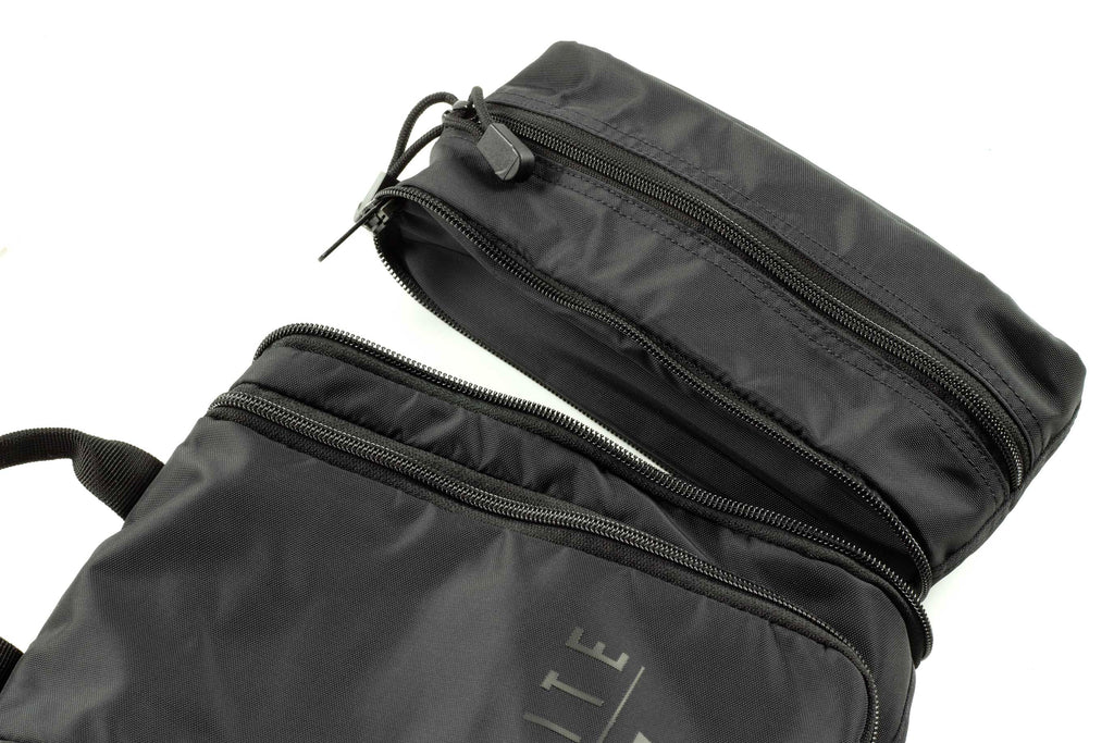 Side view of dark toiletry kit with two zip compartments and strap handles