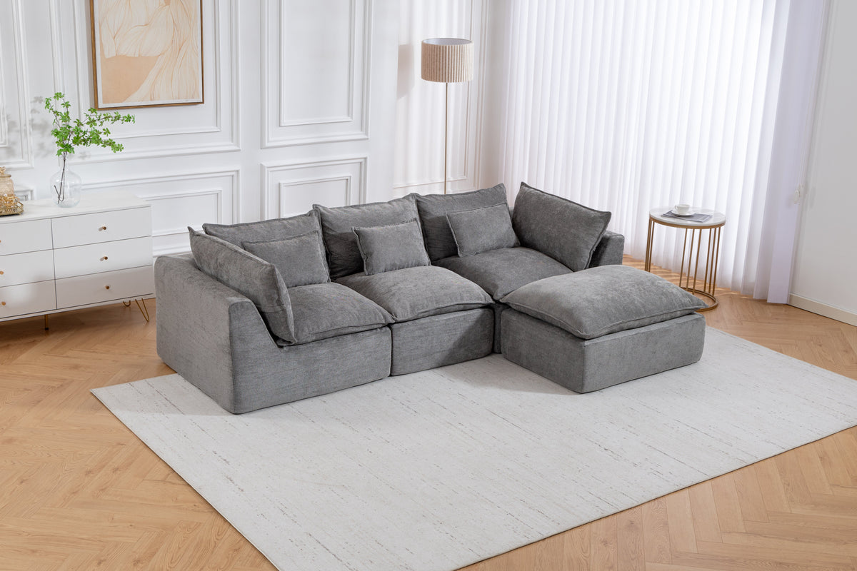 Gray sectional sofa with chaise and multiple square pillows on a light rug
