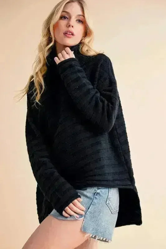 Black asymmetrical high-neck sweater with long sleeves and side slit hem