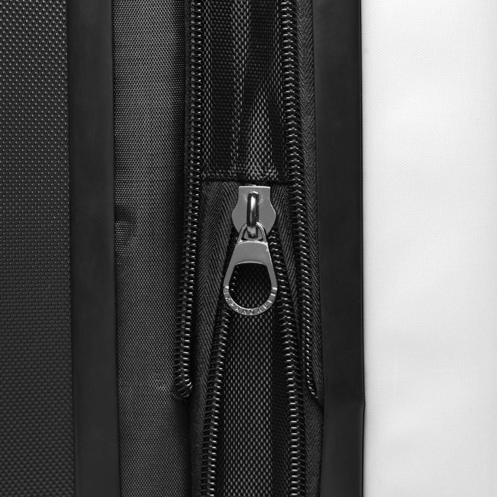Hard-shell suitcase zipper track with metal zipper pull, black textured shell