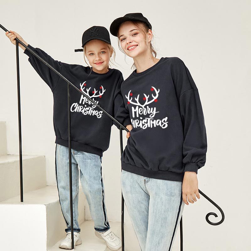 Black Christmas sweatshirt with reindeer 'Merry Christmas' print, worn by two kids.