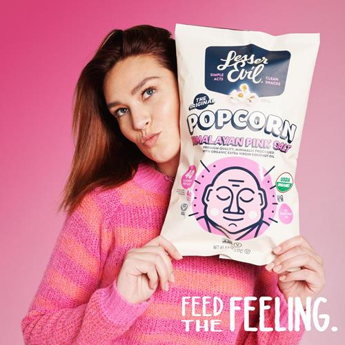 Himalayan pink salt popcorn snack bag held in hands, front label visible