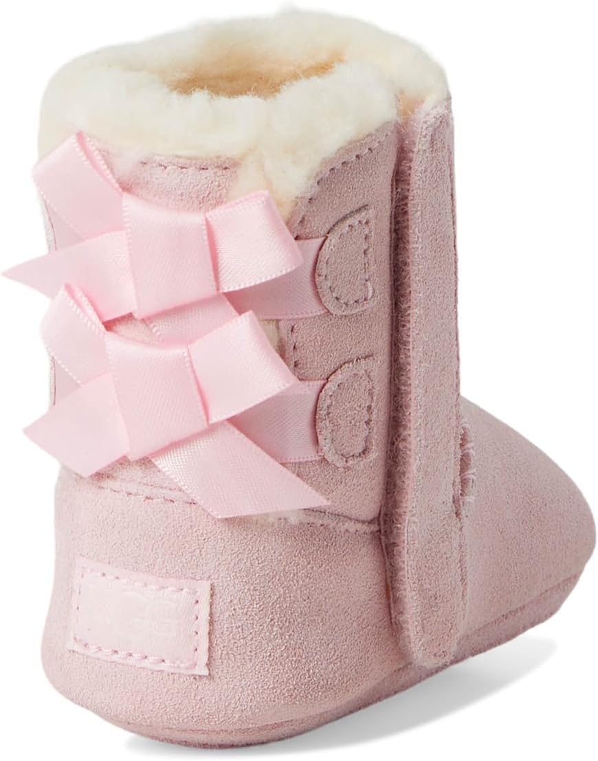 Pink baby suede booties with layered bow on the back and stitched panels