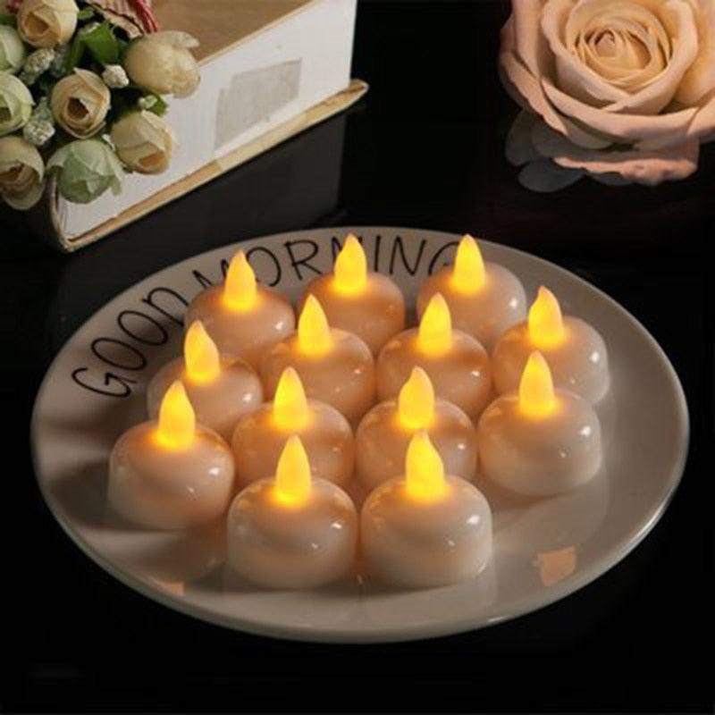Warm yellow LED floating tea lights clustered on a round tray