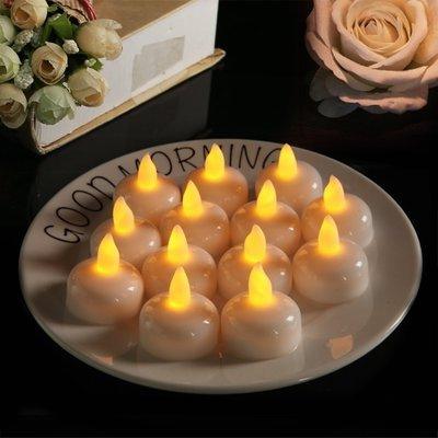 Warm yellow LED floating tea lights on a round tray