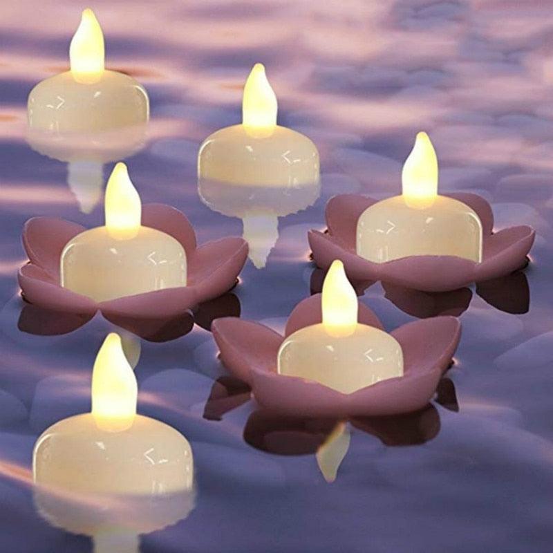 LED floating tea lights in pink lotus-shaped bases with warm yellow flames