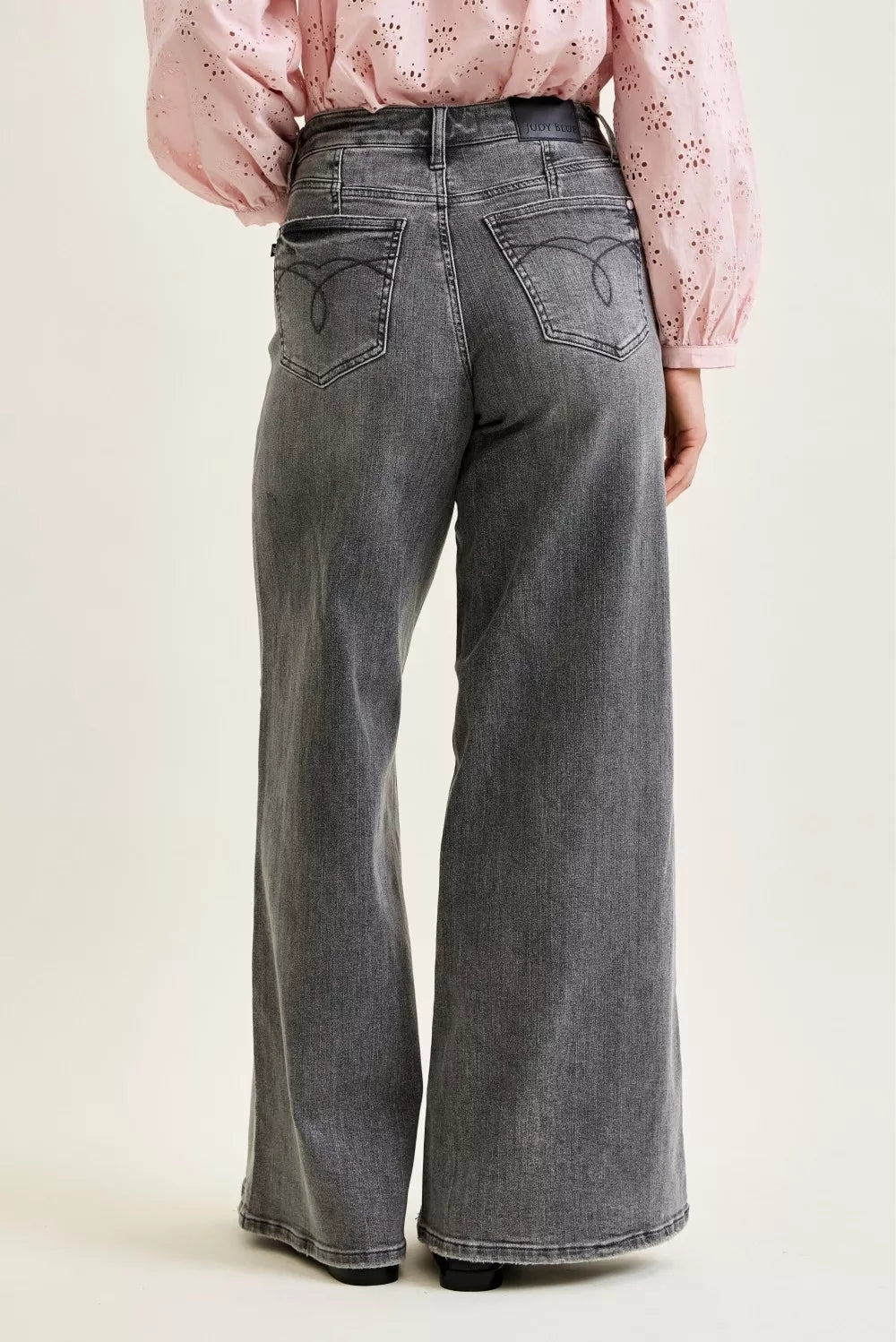 Mid-rise wide-leg gray denim jeans, back view with yoke and belt loops