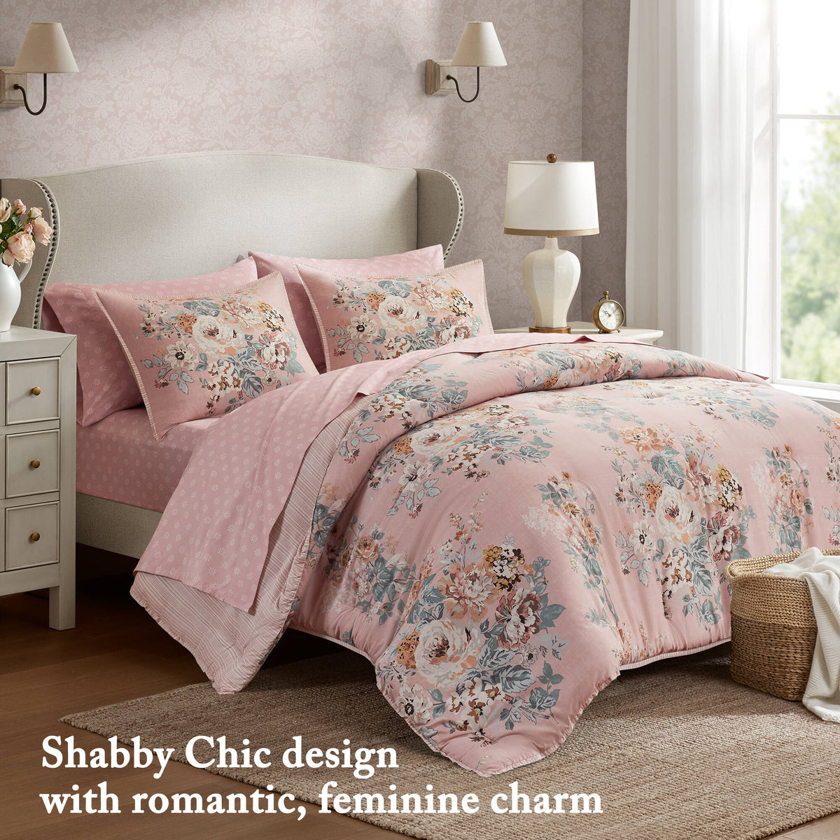Shabby-chic pink floral bedding set on bed with two pillow shams and comforter