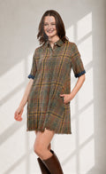 Tartan plaid shirt dress with button front, navy cuffs, and fringe hem