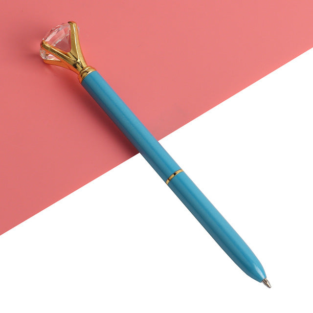 Light blue ballpoint pen with faceted gold gem top and metal ballpoint tip