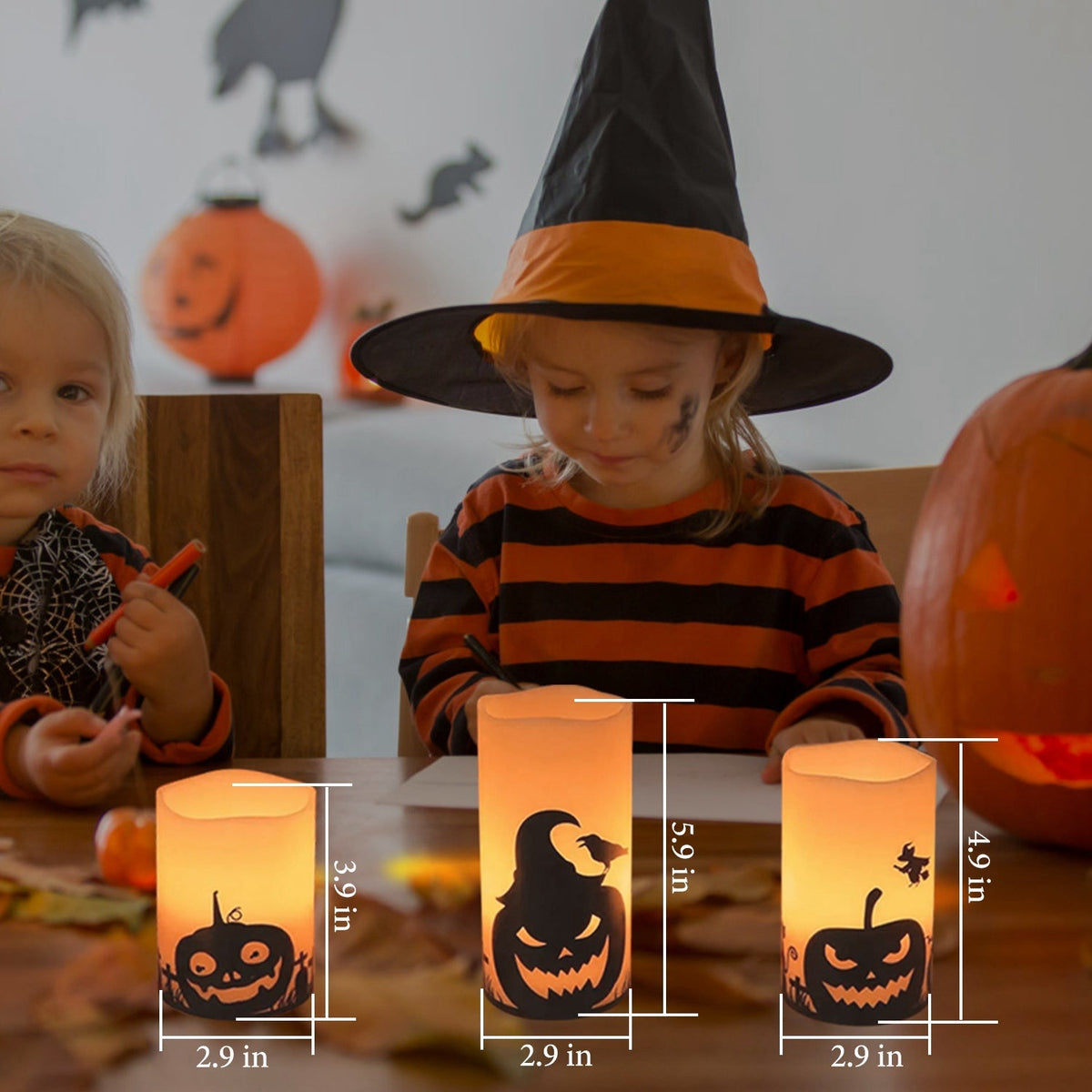 Three LED flameless candles glowing warm orange with Halloween silhouettes in a family setting